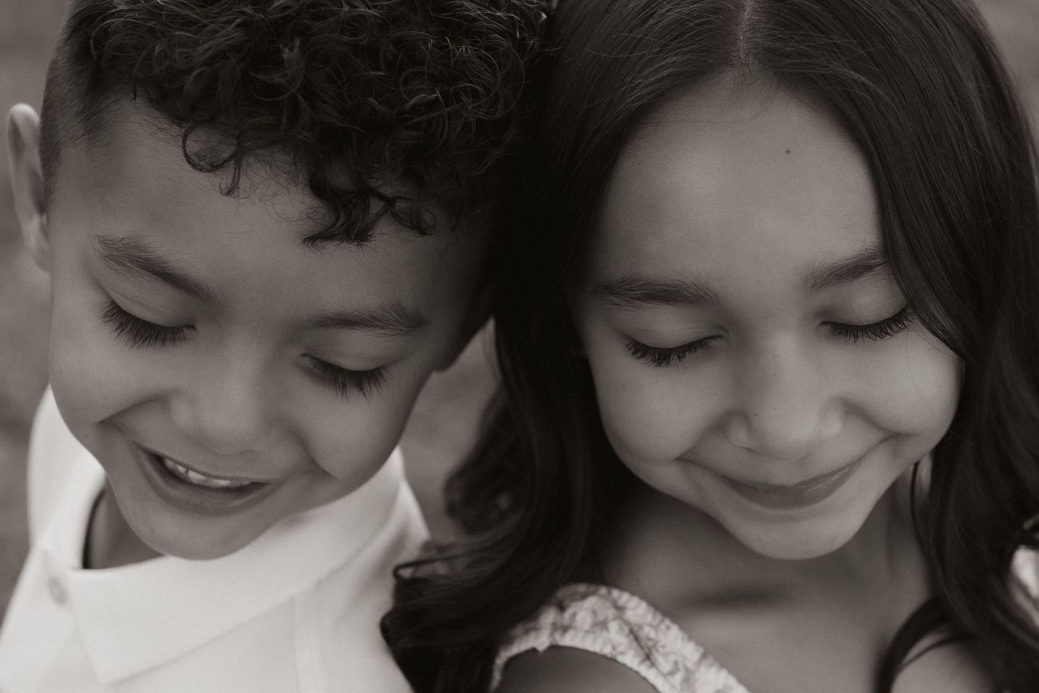Close-up black and white portrait showing joyful expressions and genuine emotion.