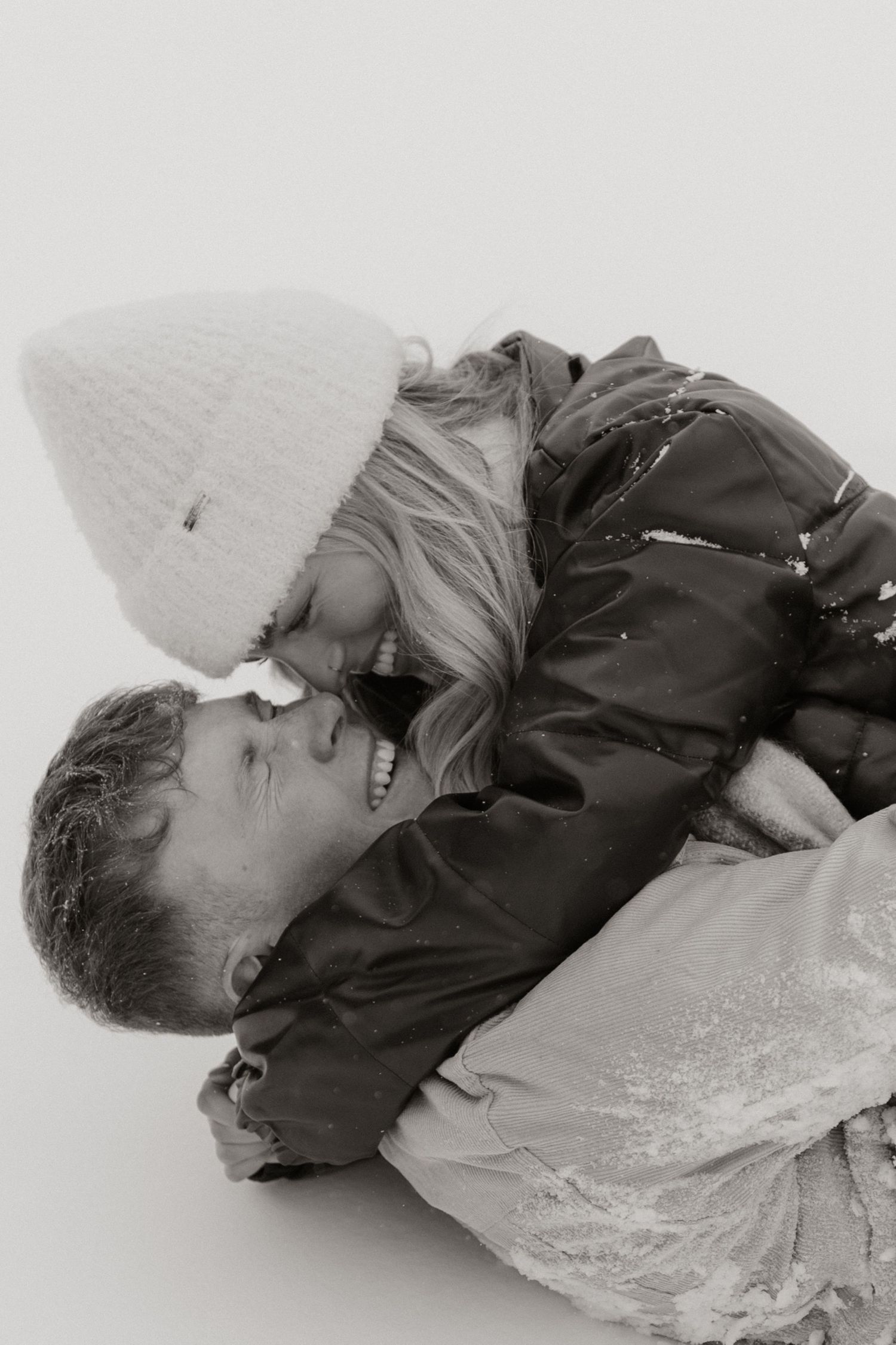 Black and white intimate portrait of couple sharing a tender moment.