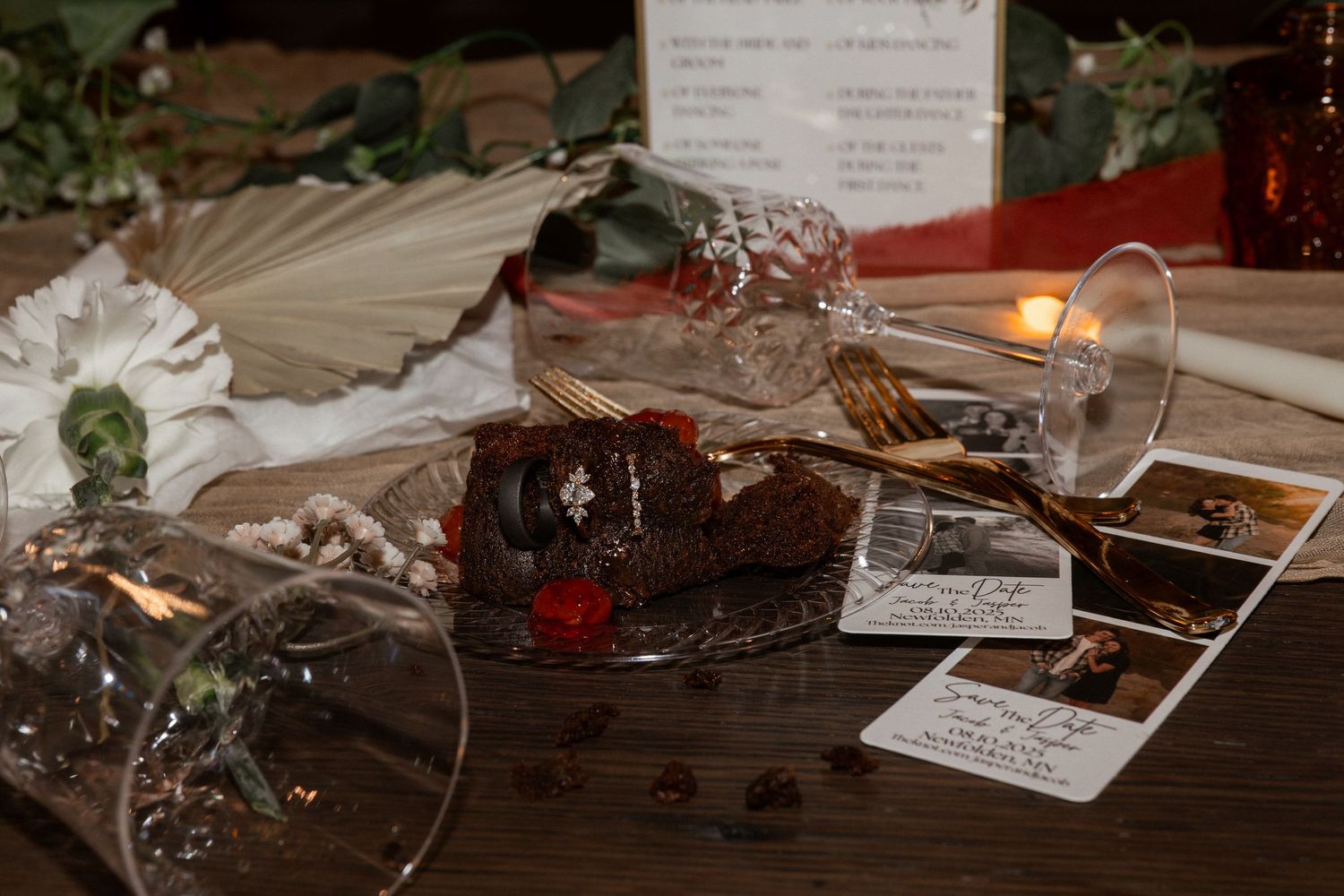 Wedding reception table decorated with candlelight and rustic details.