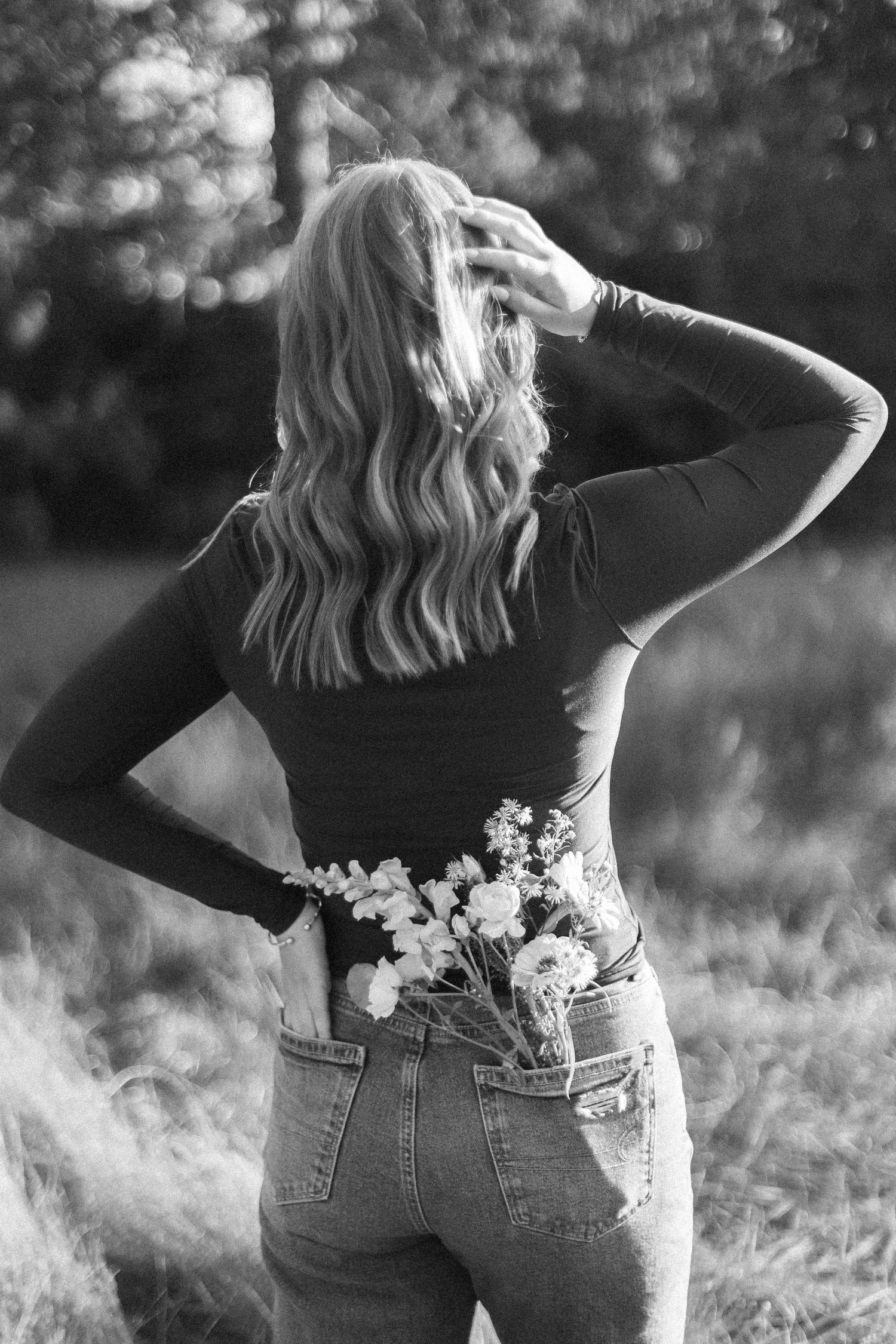 A series of black and white photos showing flowers tucked into the back pocket of blue jeans.