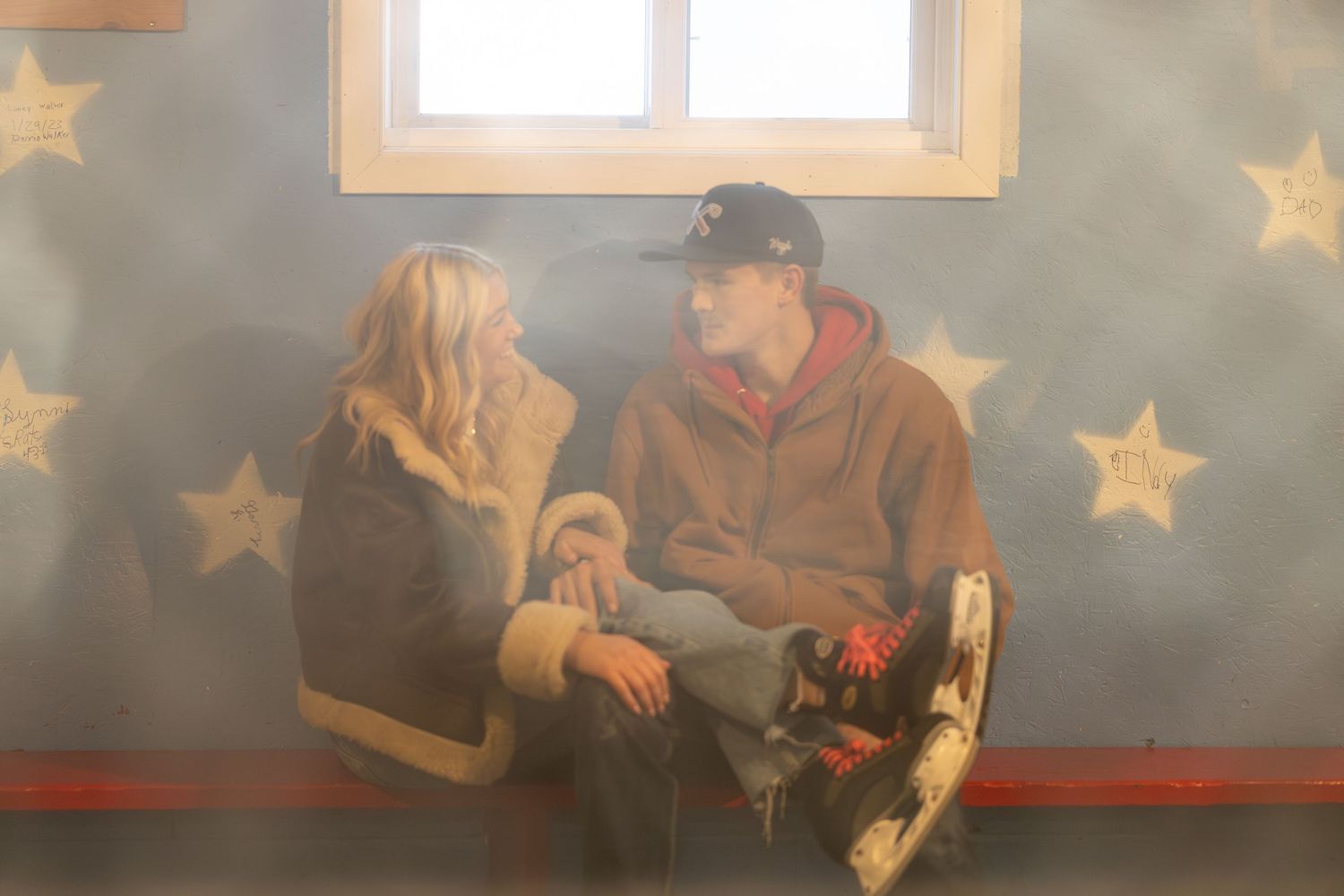 A group of people sit in chairs in a dimly lit room with star decorations on the walls.