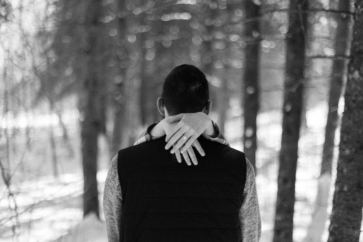 Intimate winter wedding photos in a snowy forest setting.