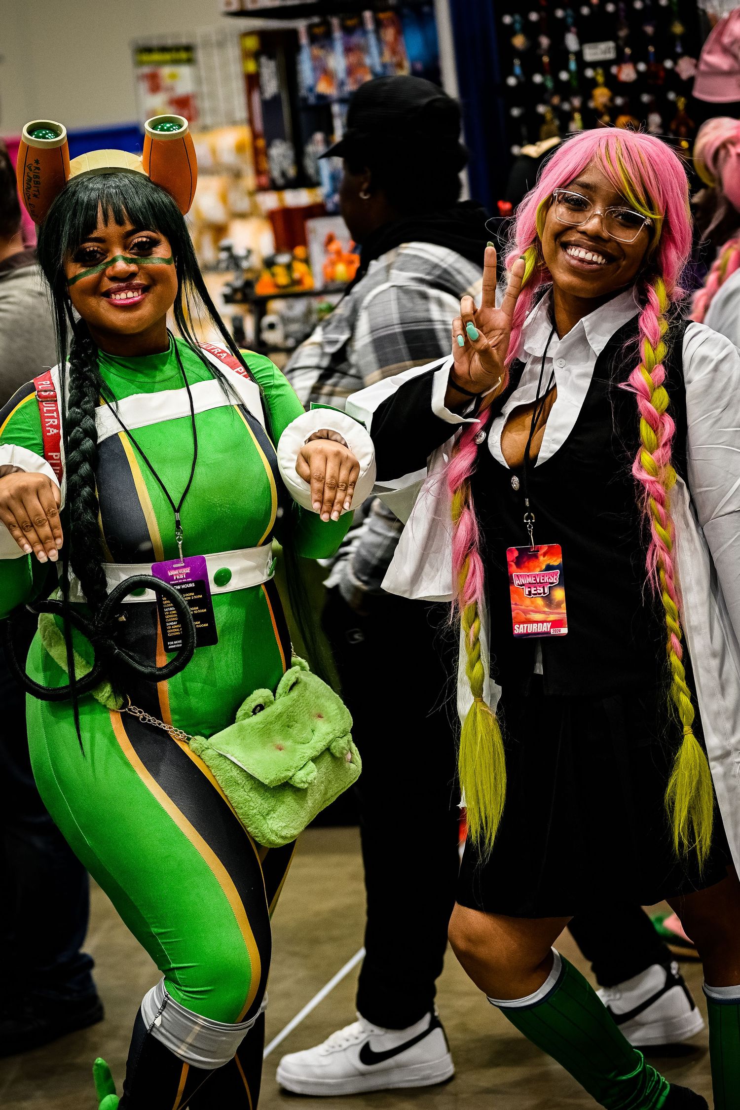 Group in colorful costumes and wigs posing playfully at convention.