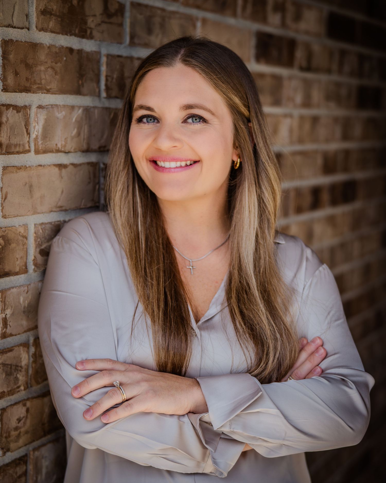 Portrait series against a brick wall backdrop showing confident poses in professional attire.