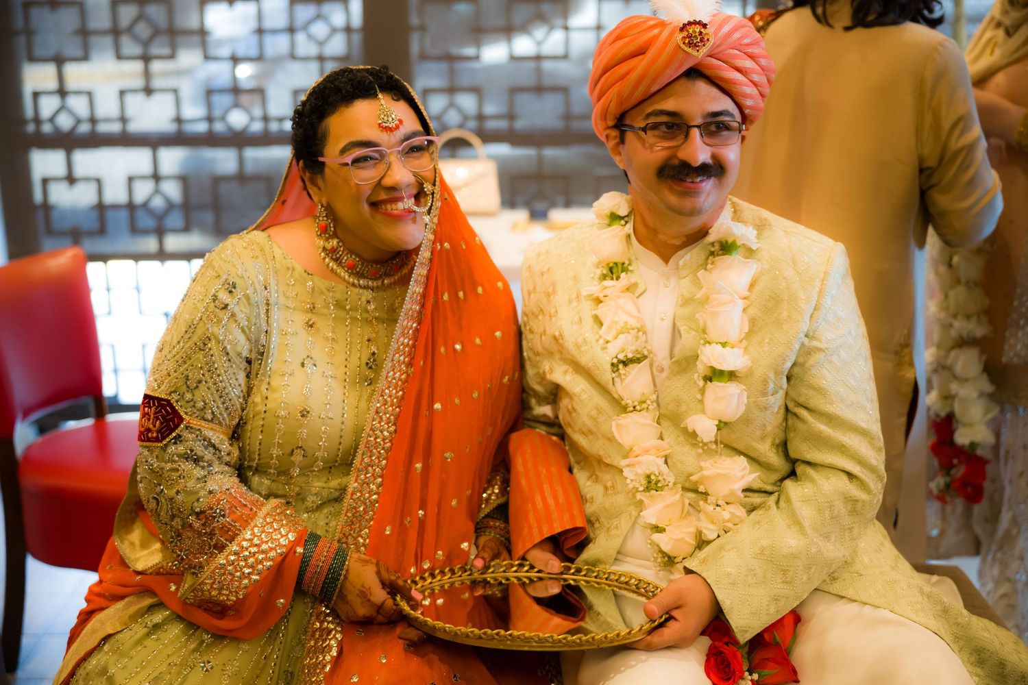 Wedding celebration with traditional Indian attire and decorative elements.