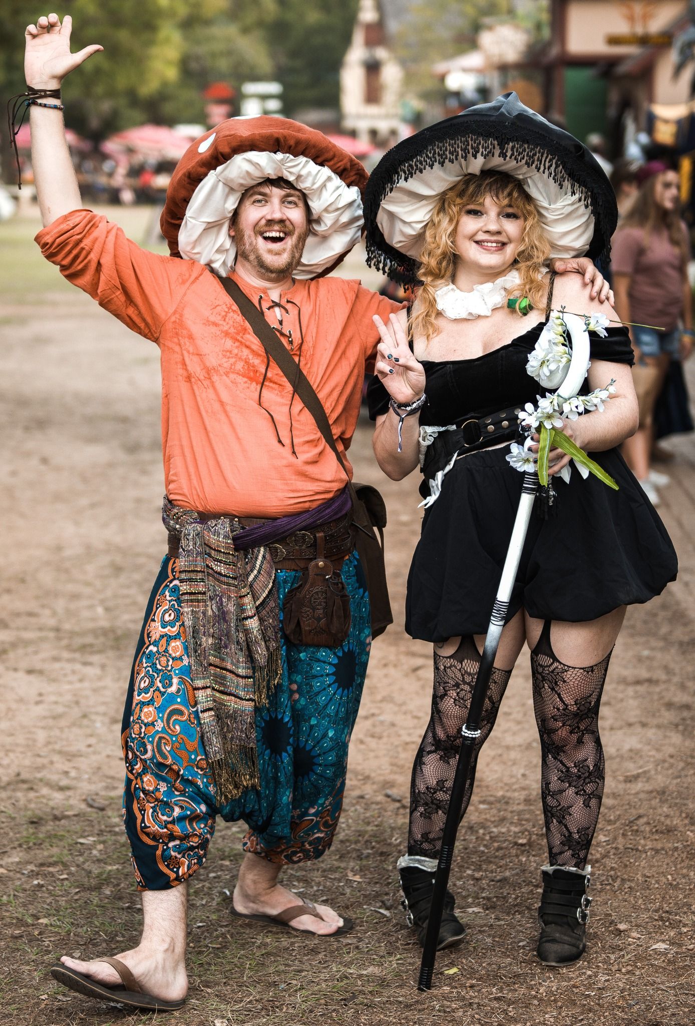 People in colorful costumes dancing and celebrating at an outdoor festival.