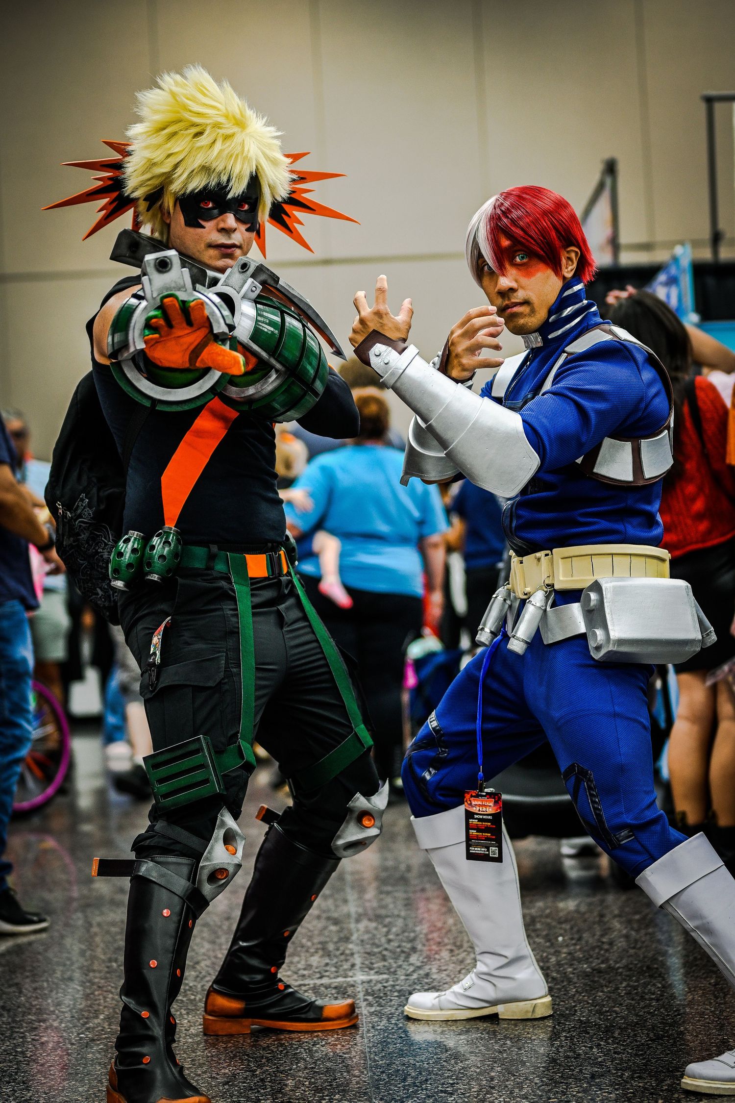 Cosplayers dressed as anime characters with spiky hair and colorful outfits pose dramatically.