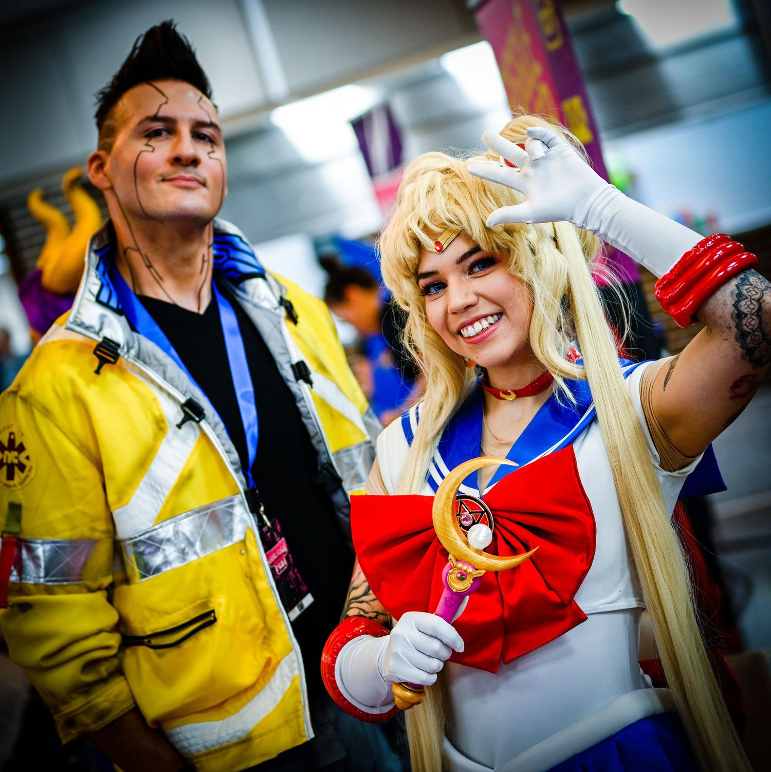 Cosplayers in colorful anime-inspired outfits posing together at convention.