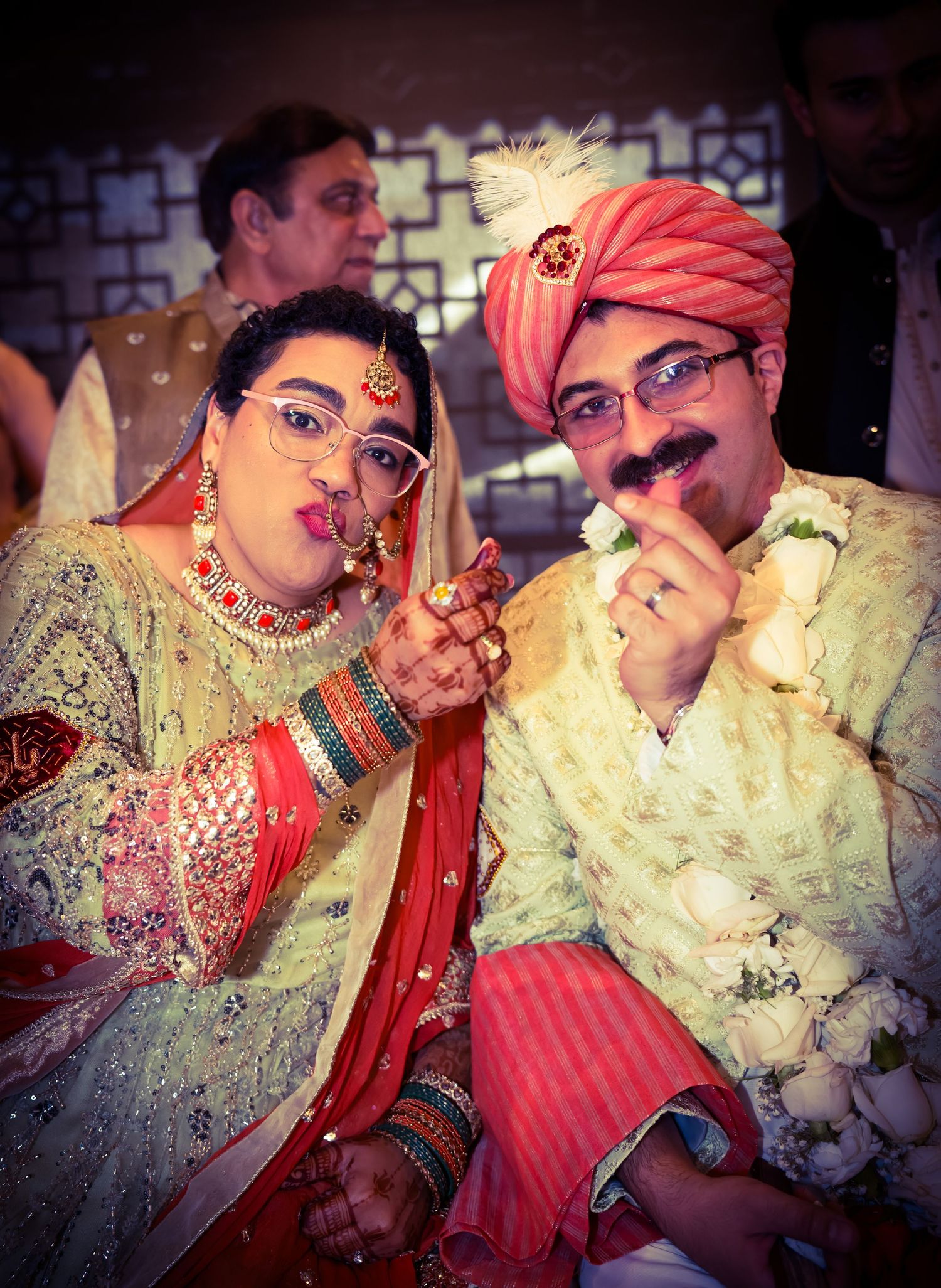 Intimate moments captured during an Indian wedding ceremony with traditional outfits.