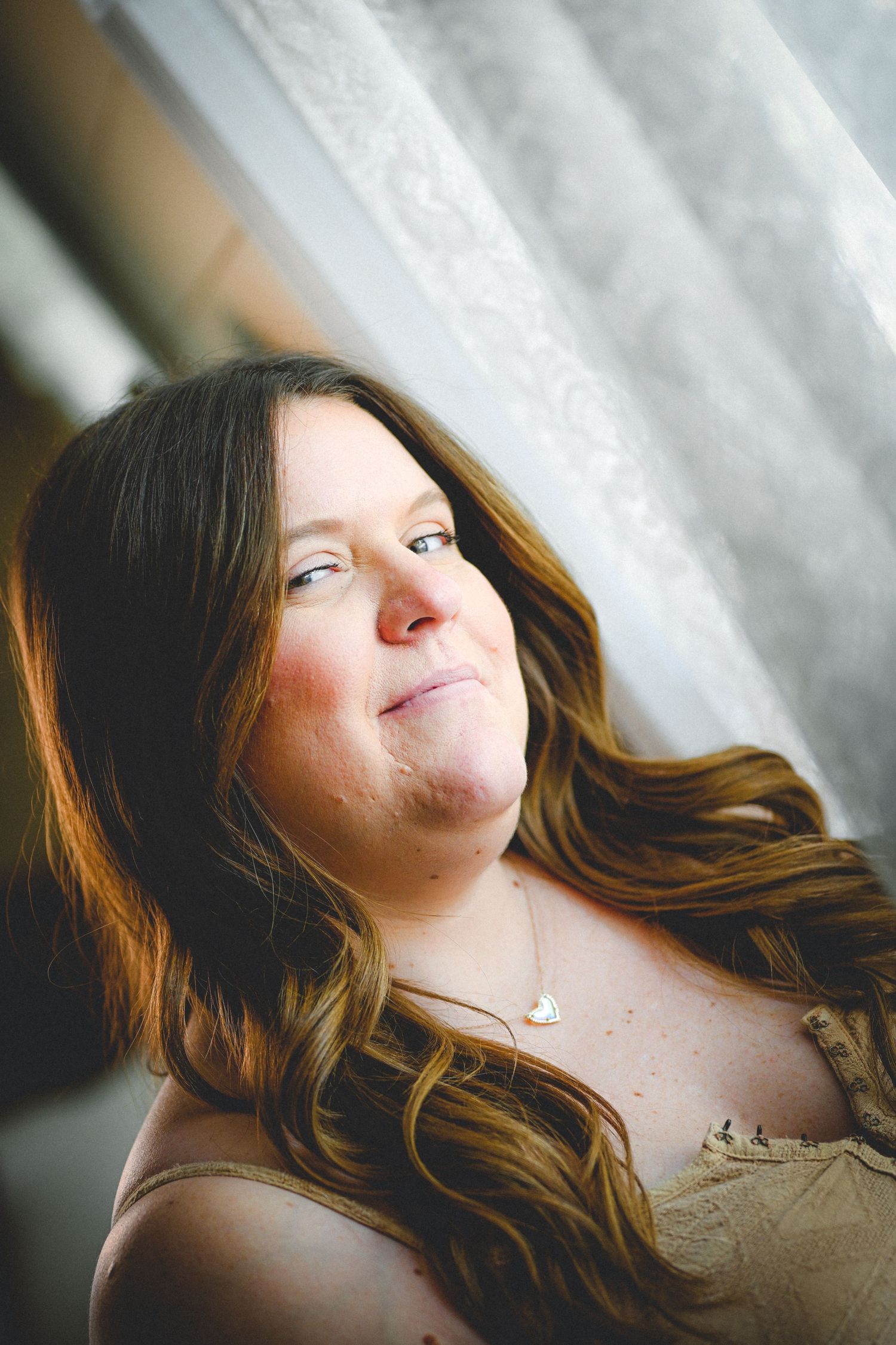 Artistic portrait series showing relaxed expressions in soft natural lighting.