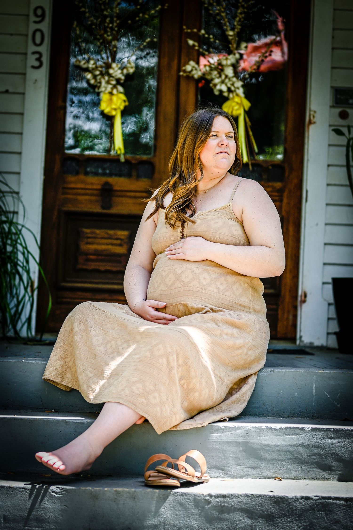 Outdoor portrait series on porch showing relaxed poses in flowing summer dress.