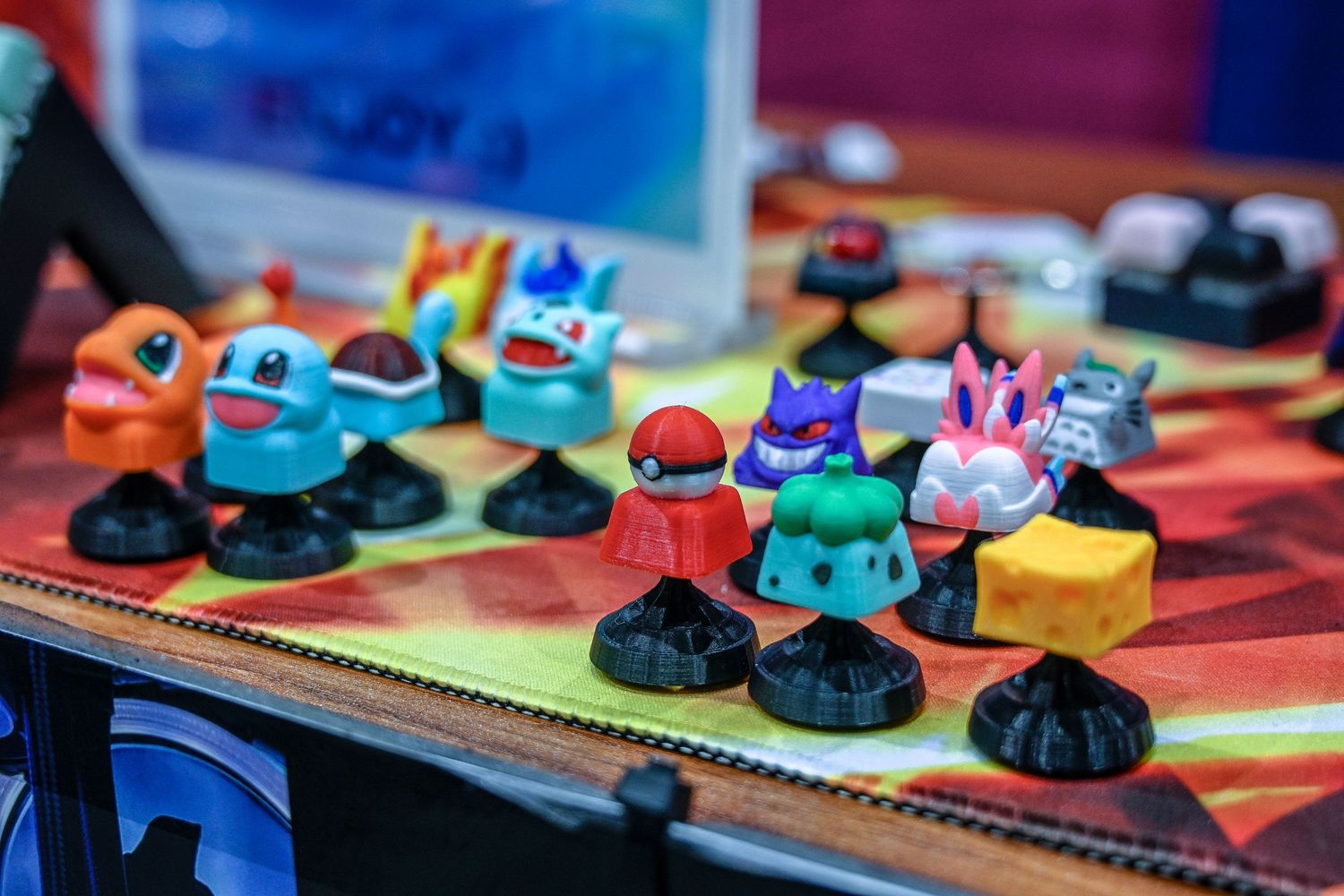 Collection of colorful Pokemon miniature figures displayed on gaming board.