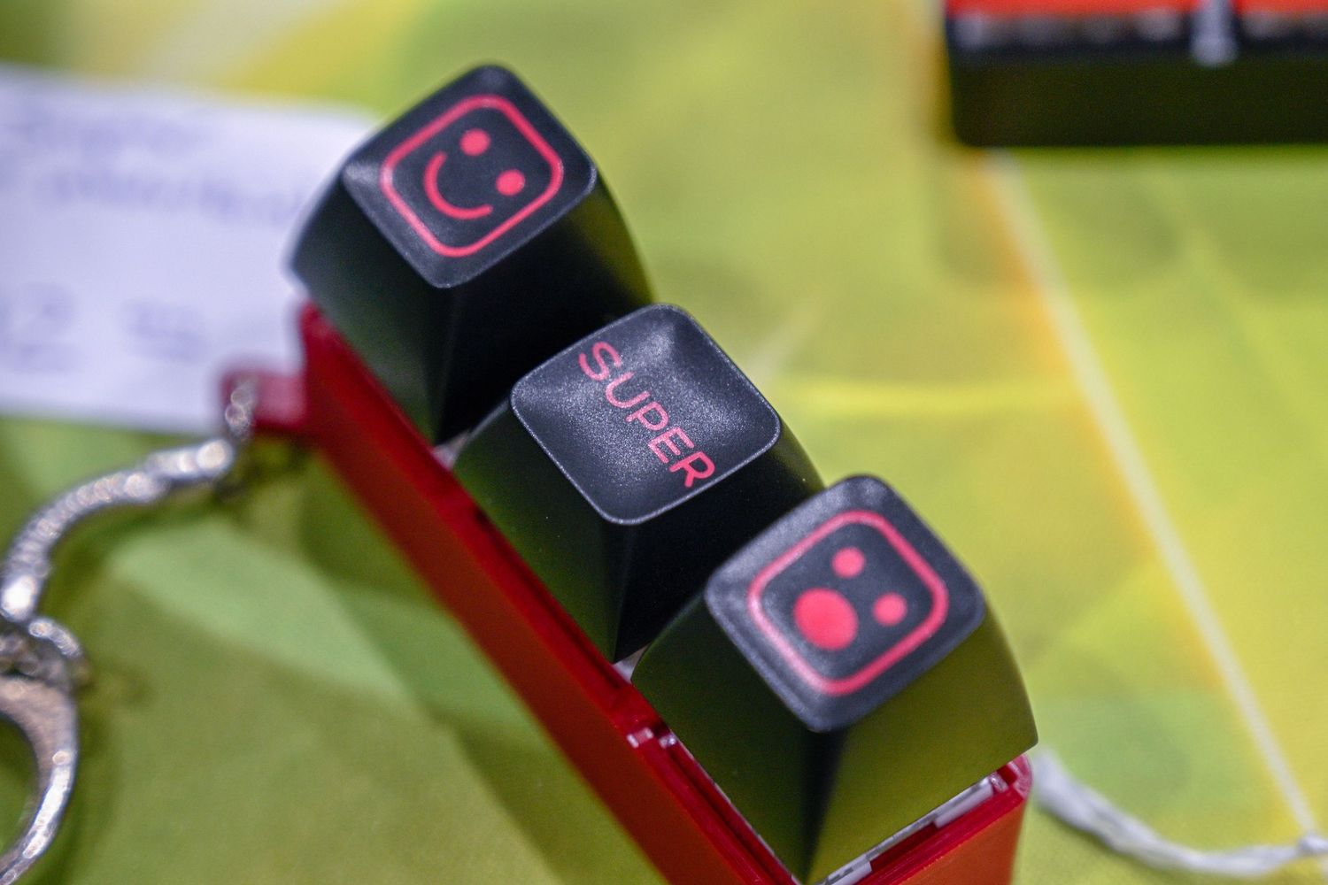 Close-up of red and black gaming or electronic accessories against green background.
