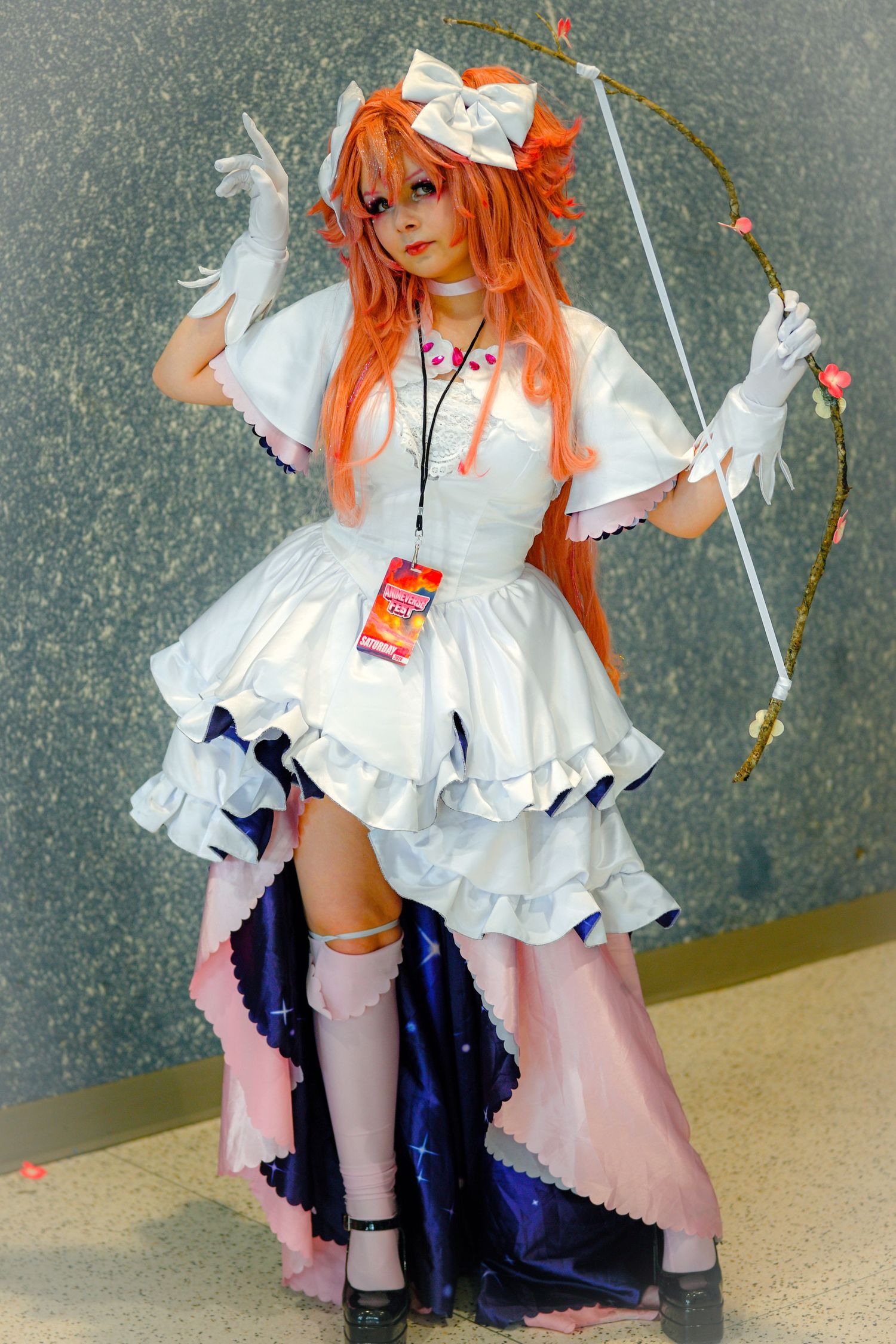 Cosplay outfit featuring white ruffled dress with blue accents and orange wig against grey background.