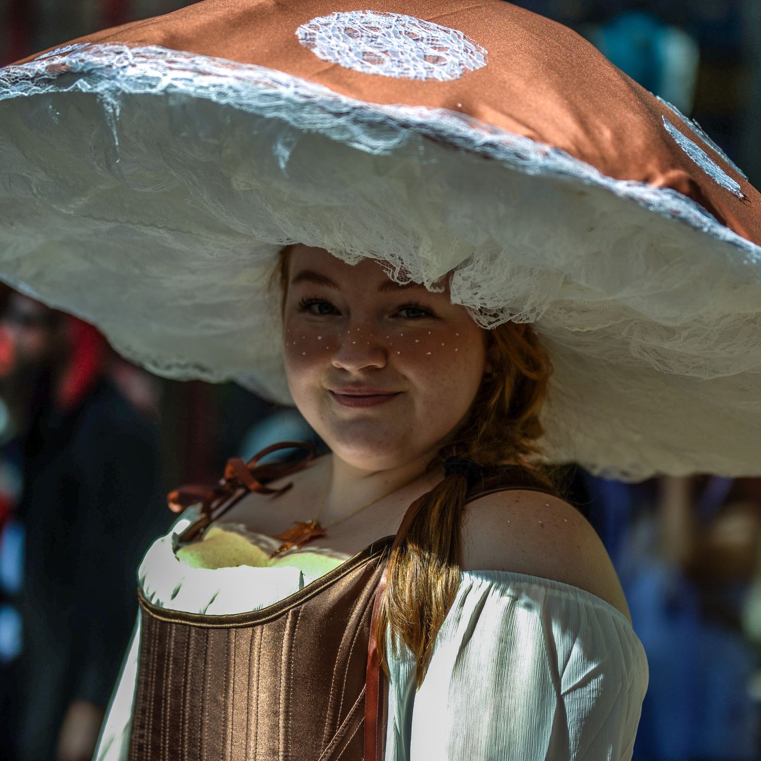 Person wearing ornate wide-brimmed white hat in traditional Mexican style.