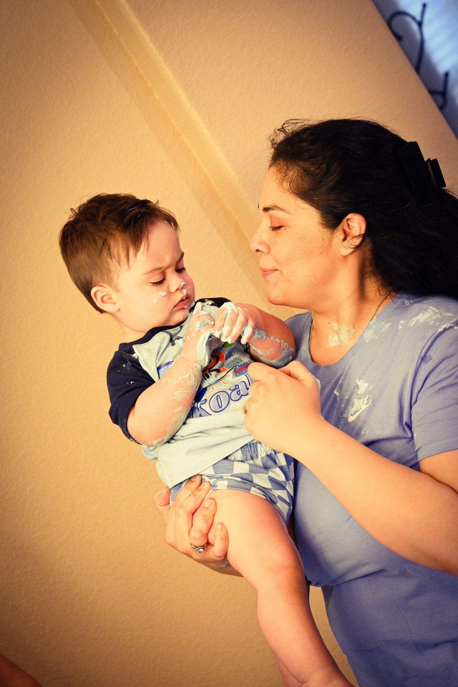 A tender moment between parent and child lying down together.