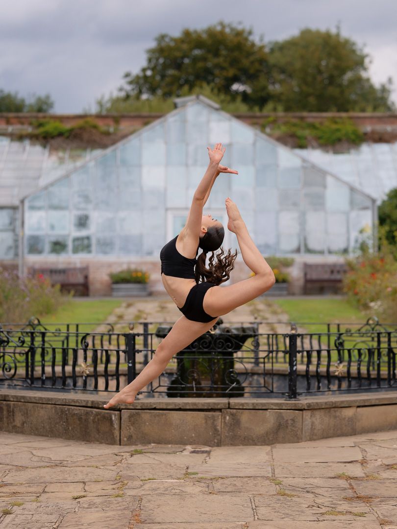 Athletic leaps and jumps photographed against cloudy sky and urban backdrop.