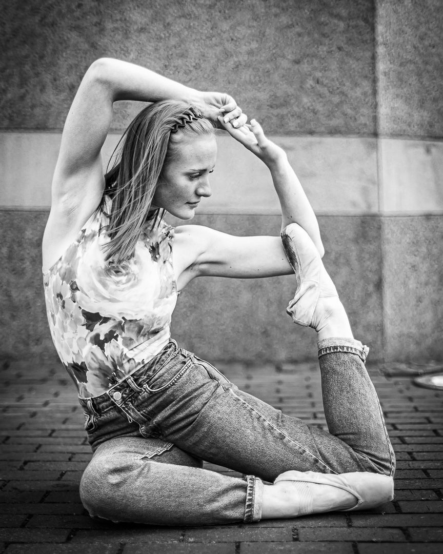 Black and white photo series showing graceful stretching poses on a brick surface.