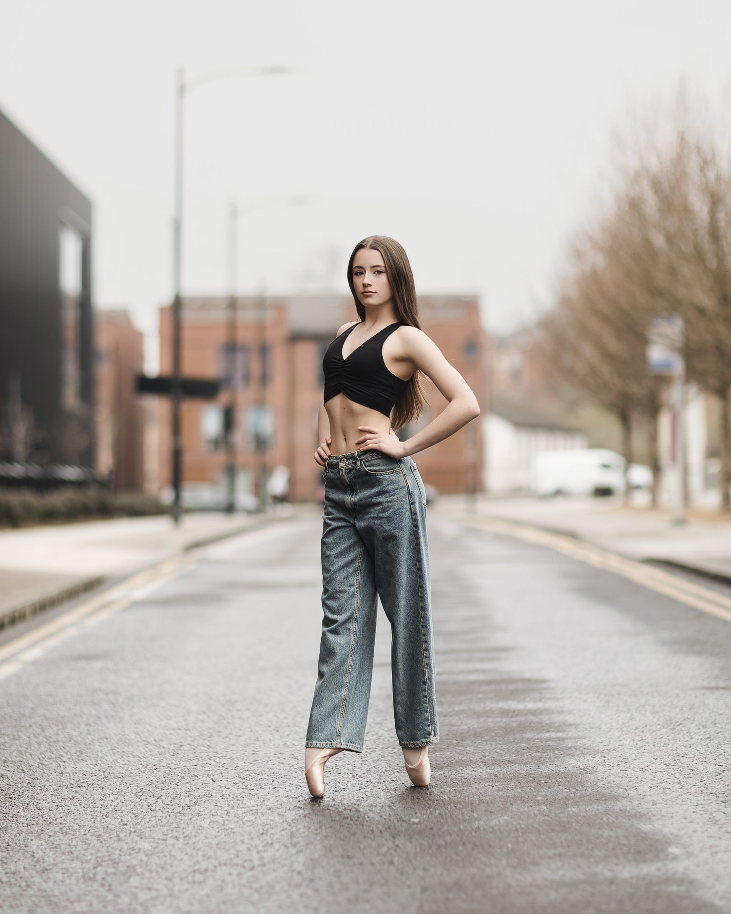 A series of artistic poses on an urban street showing movement in denim jeans and black top.