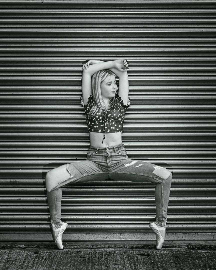 Black and white series showing dance poses against industrial metal shutters.