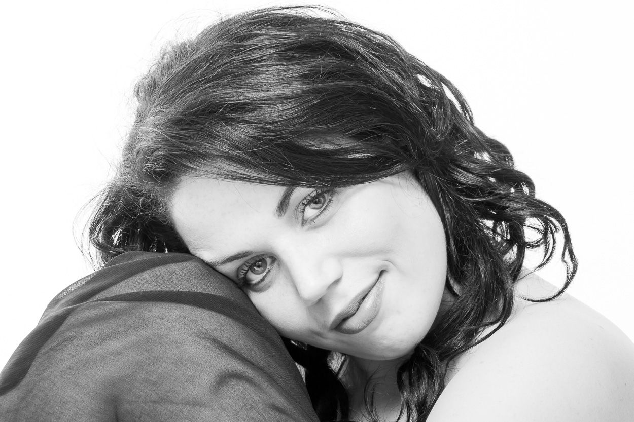 Artistic black and white headshot series showing different poses and expressions.