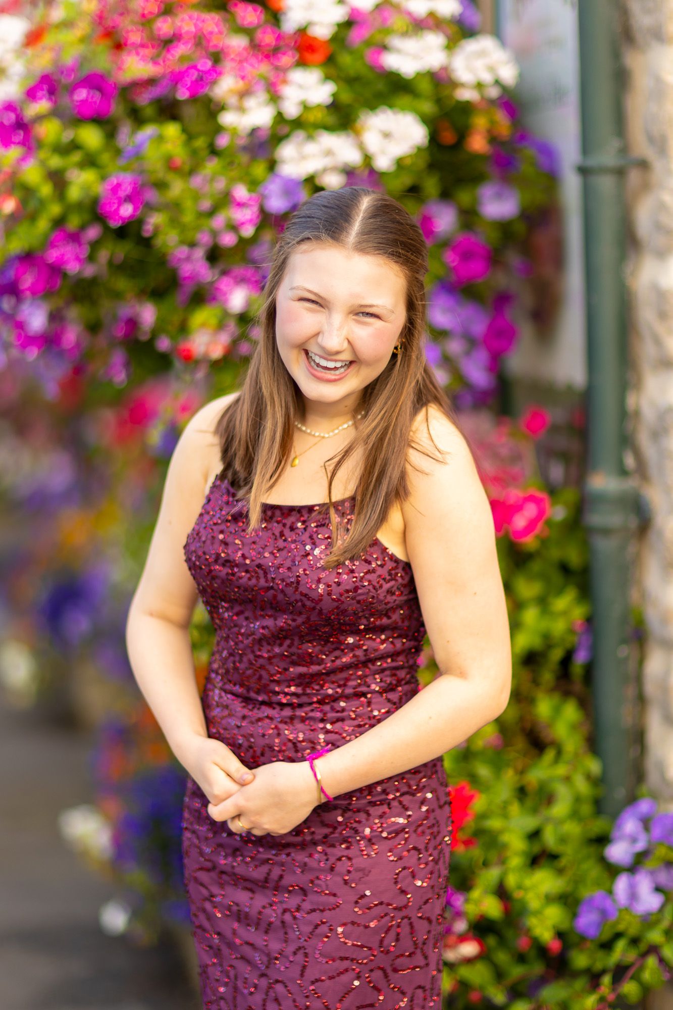 Vibrant pink and purple flowers frame formal portrait session outdoors.