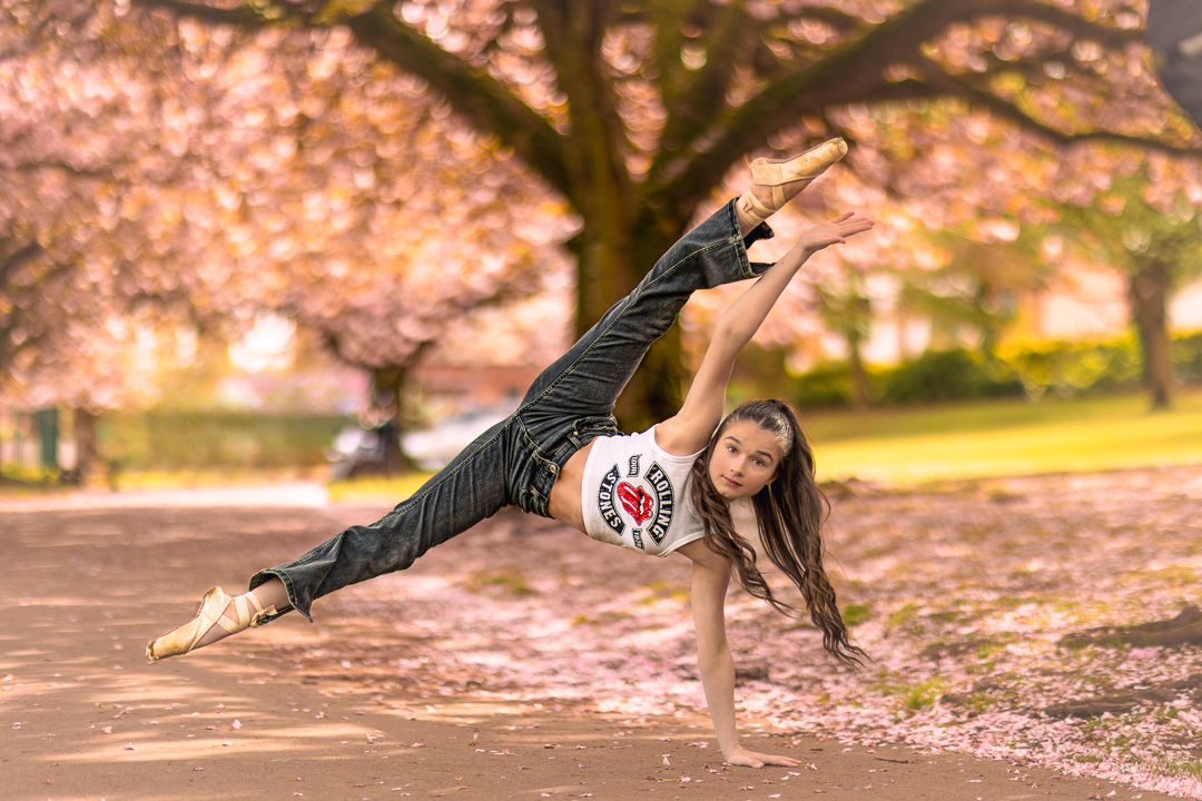Dance sequence under pink cherry blossoms showing graceful floor movements.
