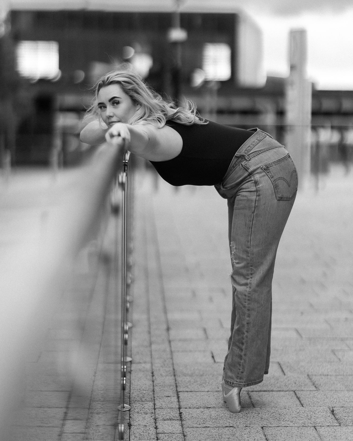 Black and white series of dance-like movements showing legs and feet against a tiled floor.