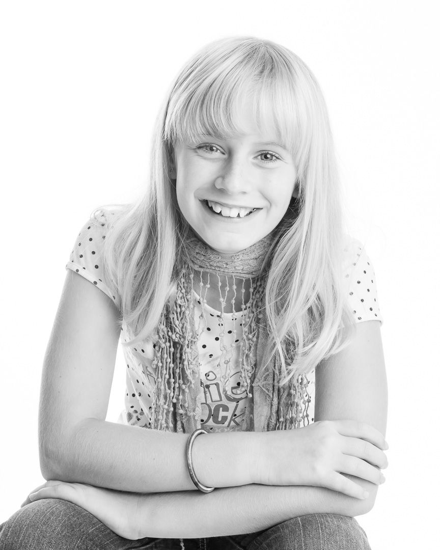 Black and white portrait series showing a young person with blonde hair making playful expressions.