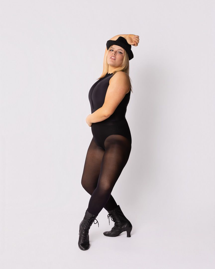 Figure in black attire striking dramatic poses against light background in studio setting.