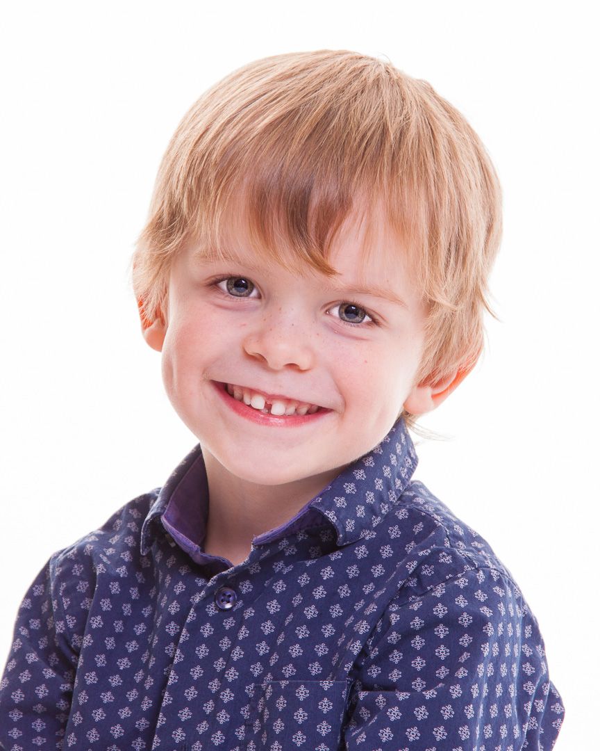 A series of close-up portrait shots showing bright smiles and blue patterned clothing.