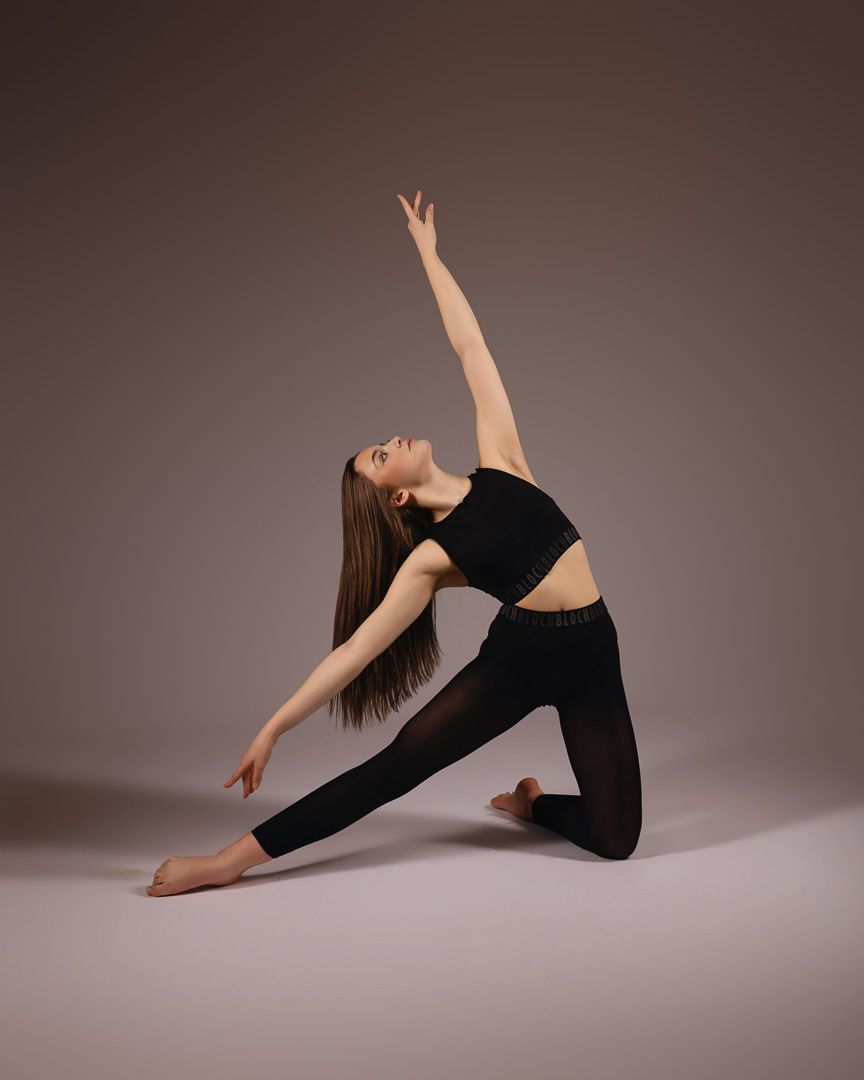 A dancer in black attire performs a series of graceful poses against a neutral studio backdrop.