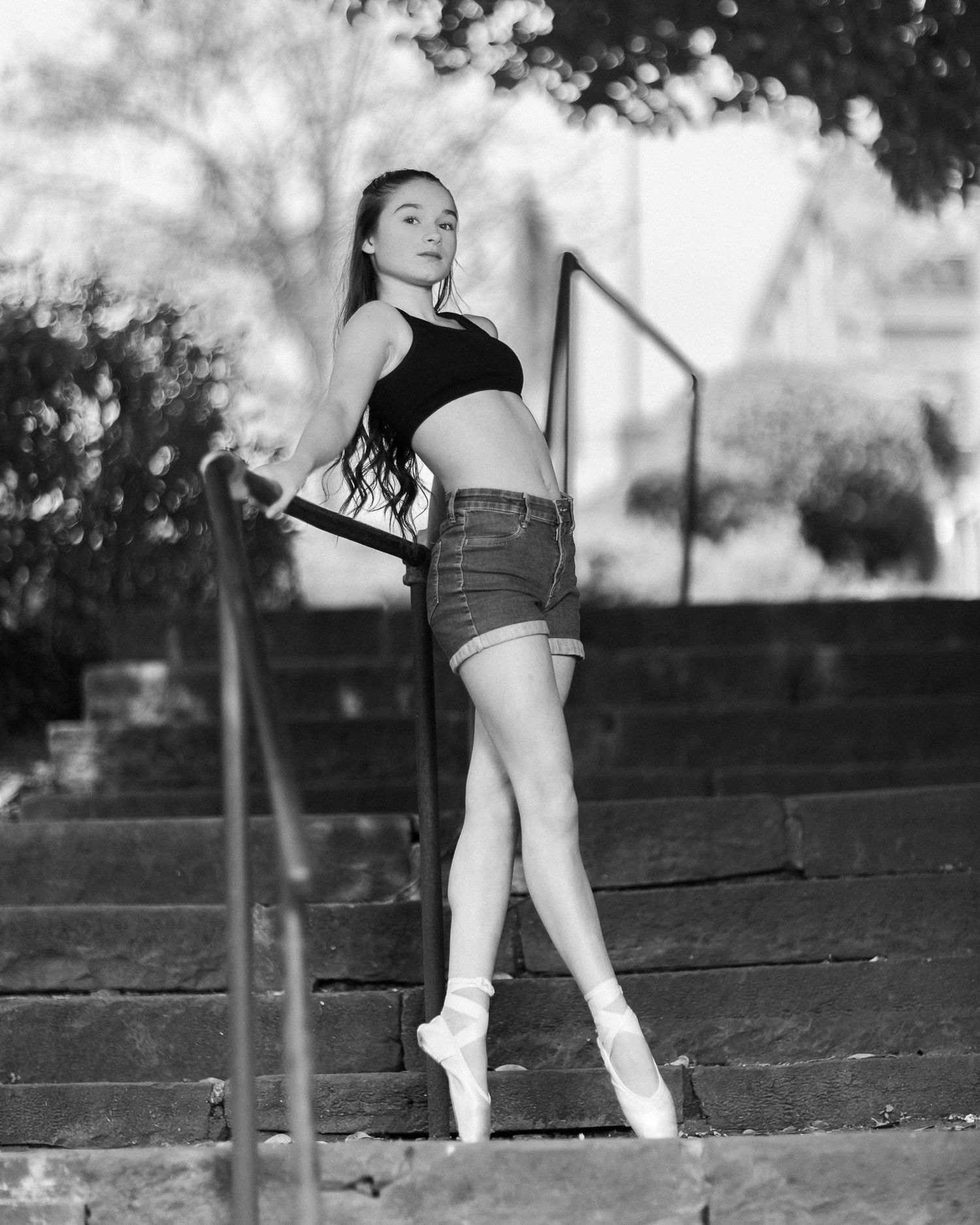 Black and white photos show ballet dancer practicing graceful movements on outdoor steps.