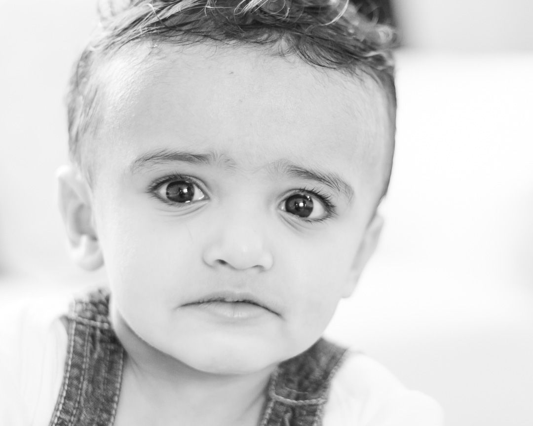 Close-up black and white portrait shots showing expressive facial features.