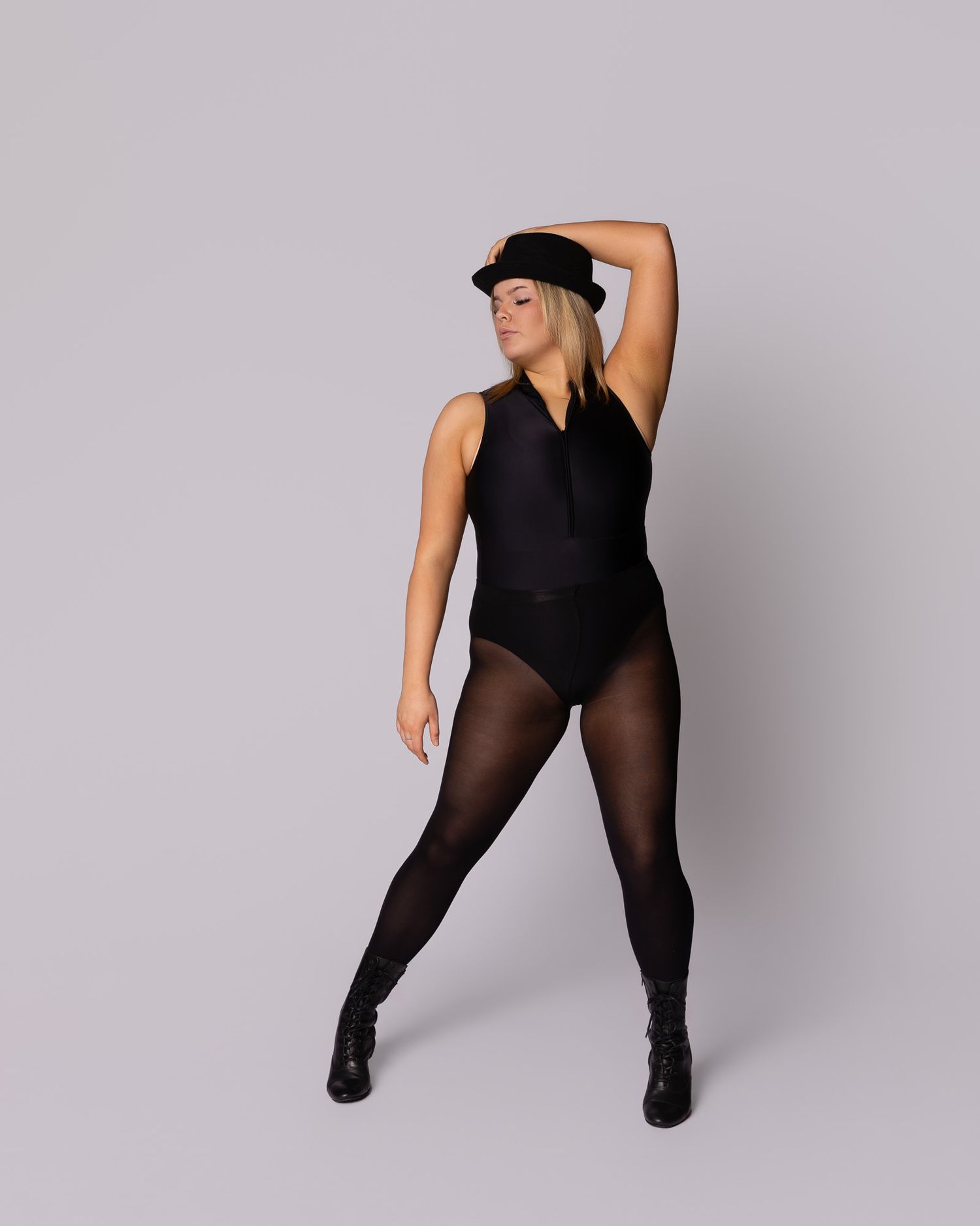 Figure in black dance attire strikes dynamic poses against gray backdrop in artistic photo series.