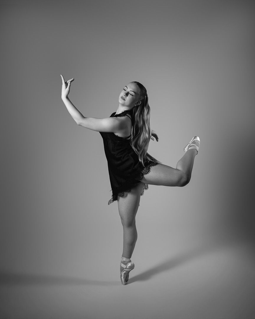 Black and white photo series of a ballet dancer performing graceful poses in a flowing dress against a simple backdrop.