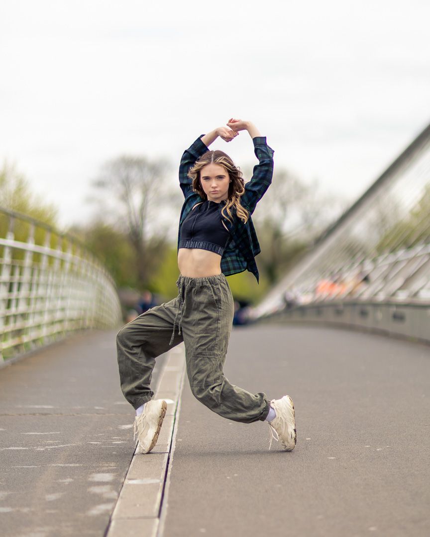 Urban dance sequence showing street style moves on concrete bridge.