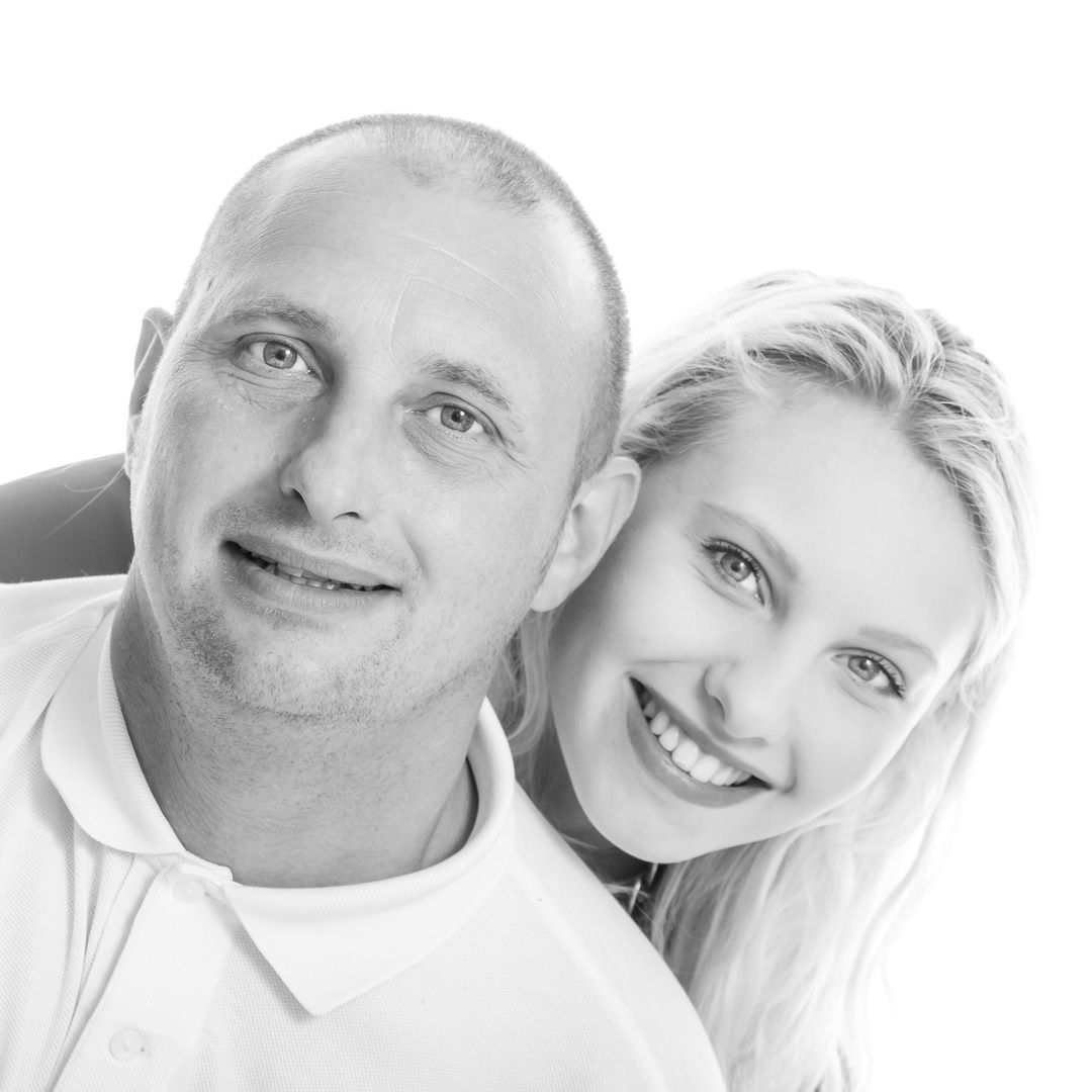 Four close-up portrait photos showing happy smiling expressions in black and white.
