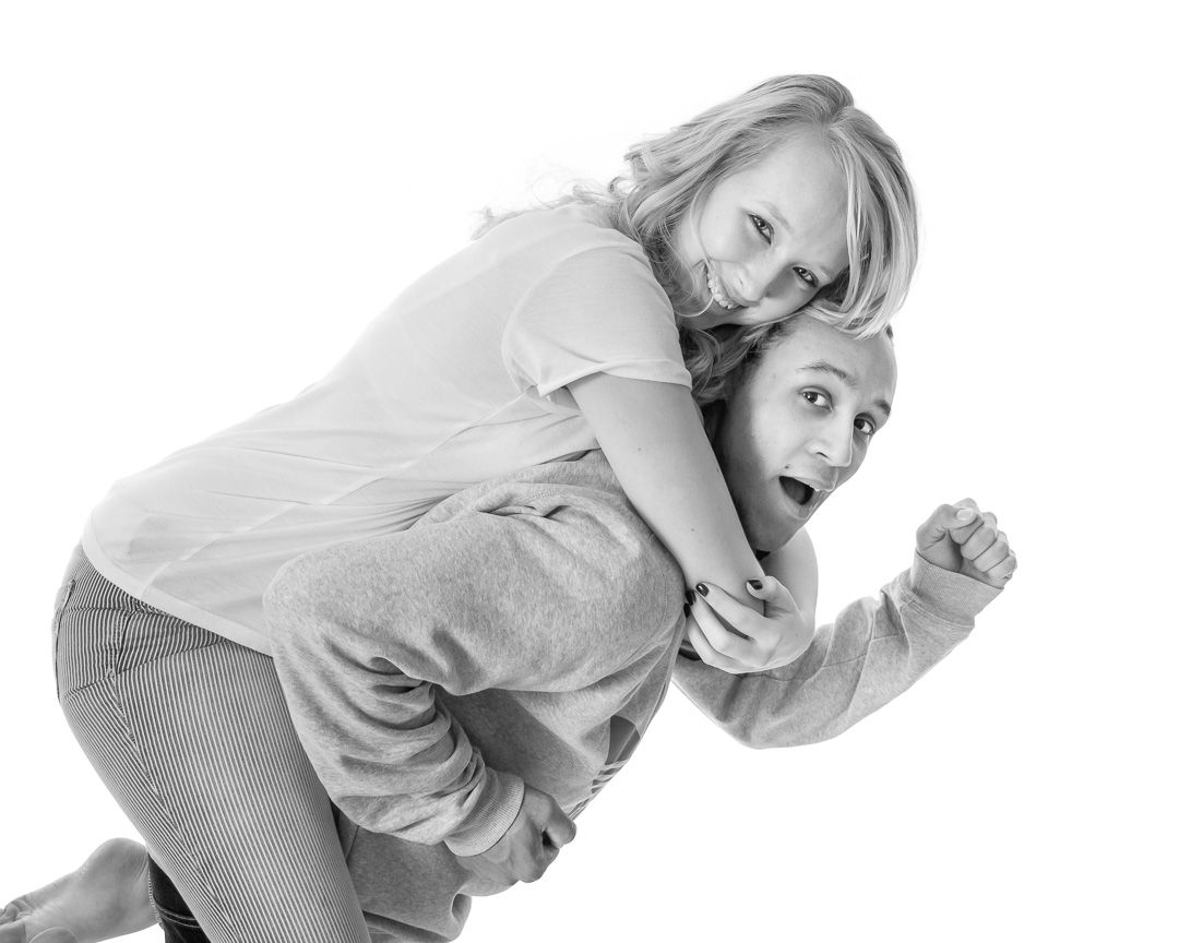 Playful sequence of two people performing lighthearted movements in white studio setting.