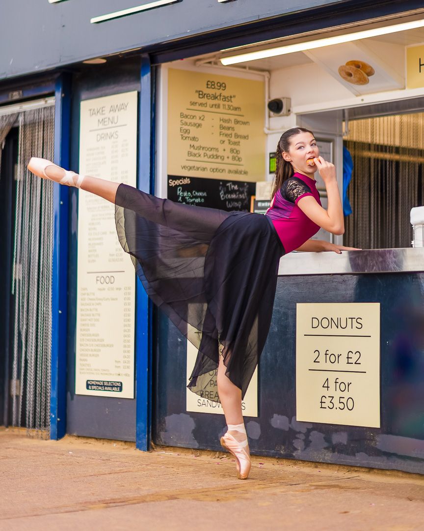 Dance movements captured outside storefront with menu signs visible in background.