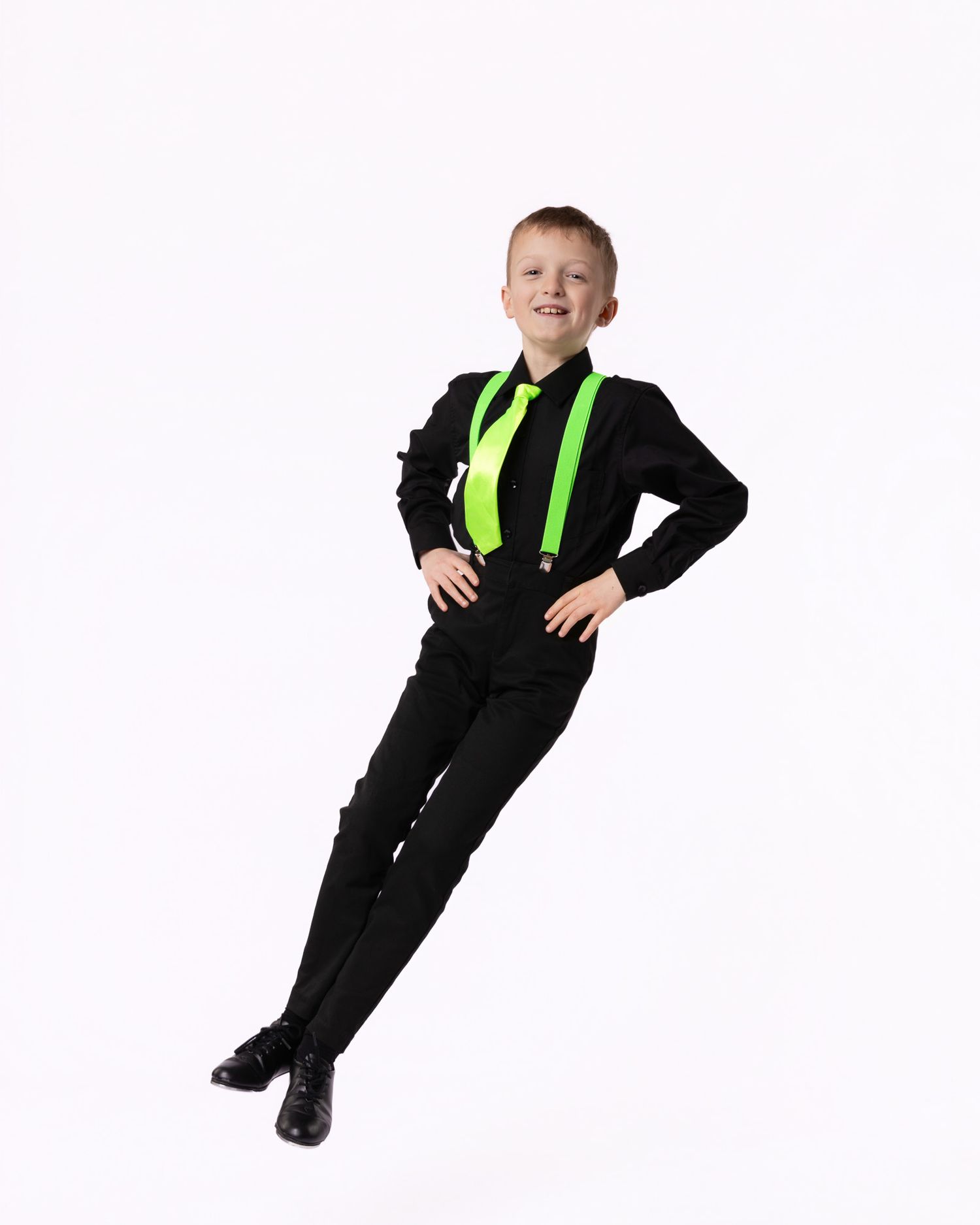 A young person in a black and neon yellow jumpsuit strikes three different poses against a white background.