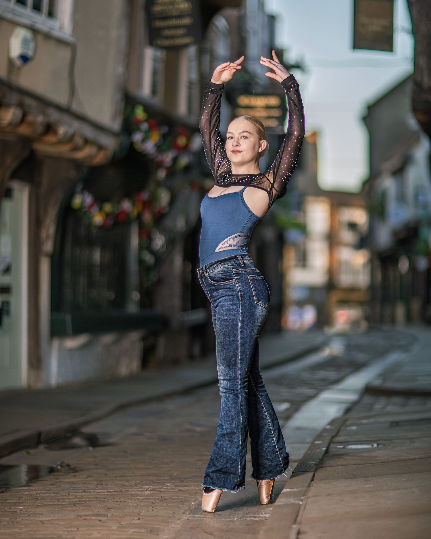 Dancer in denim performs graceful leaps and turns along a city sidewalk in a dynamic photo sequence.