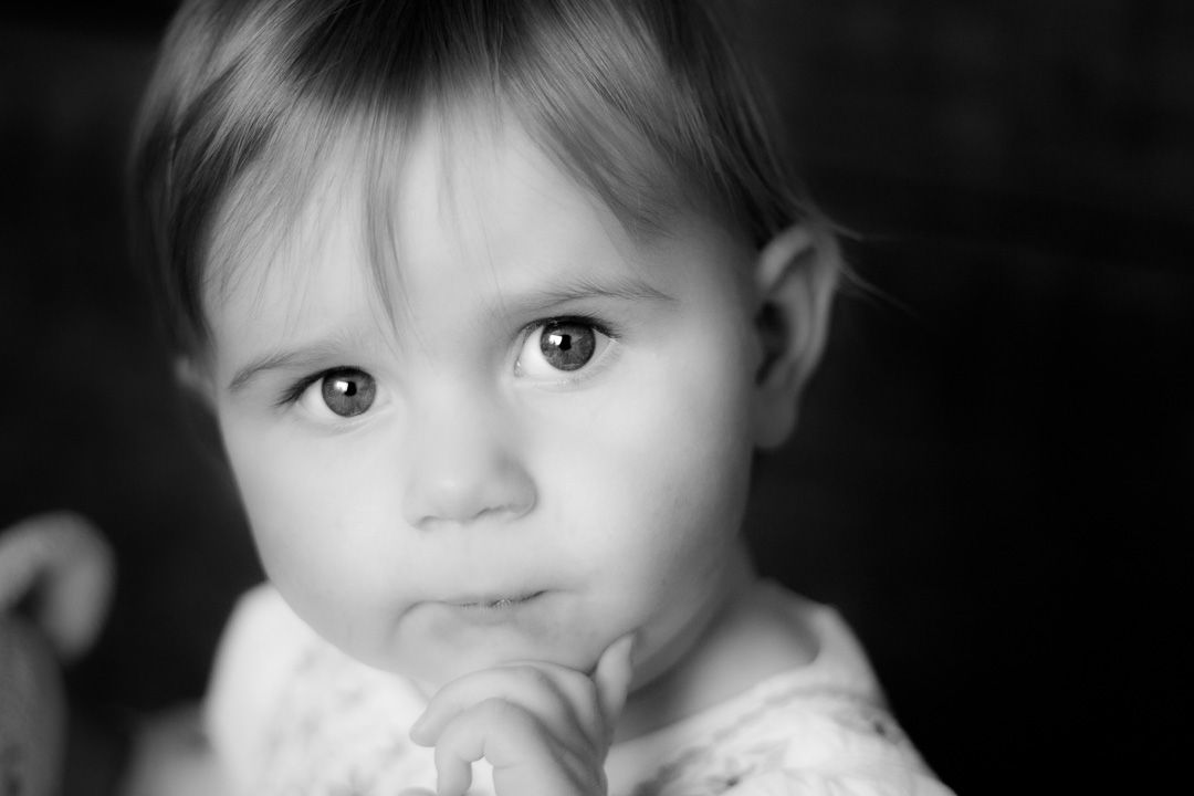 A collection of six black and white close-up photographs showing expressive eyes and faces in soft lighting.