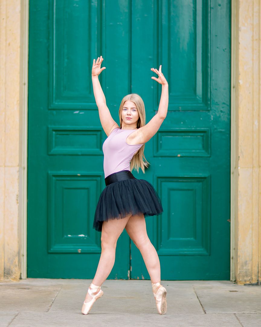 Dance poses captured in front of turquoise doors showing graceful movements in natural light.