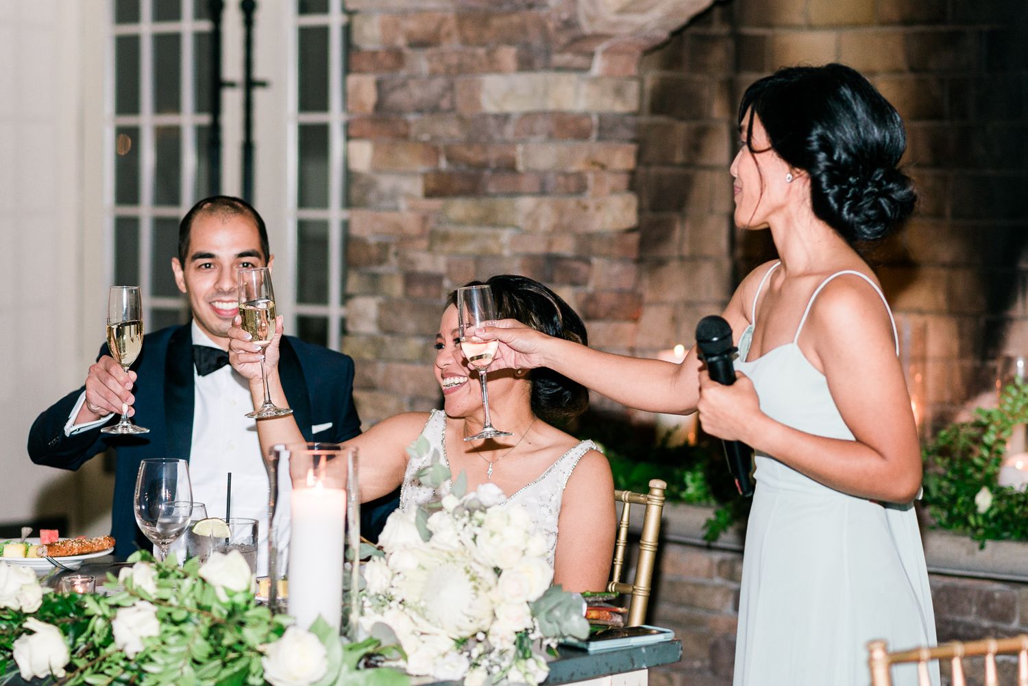 A bridesmaid toasting the bride and groom at a wedding ceremony.