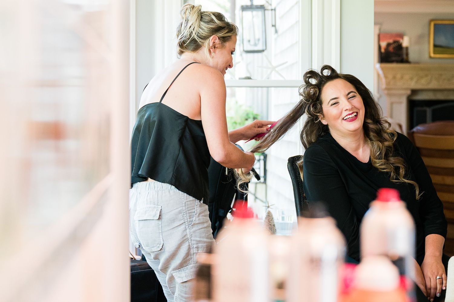 A bride gets her hair done before her wedding.