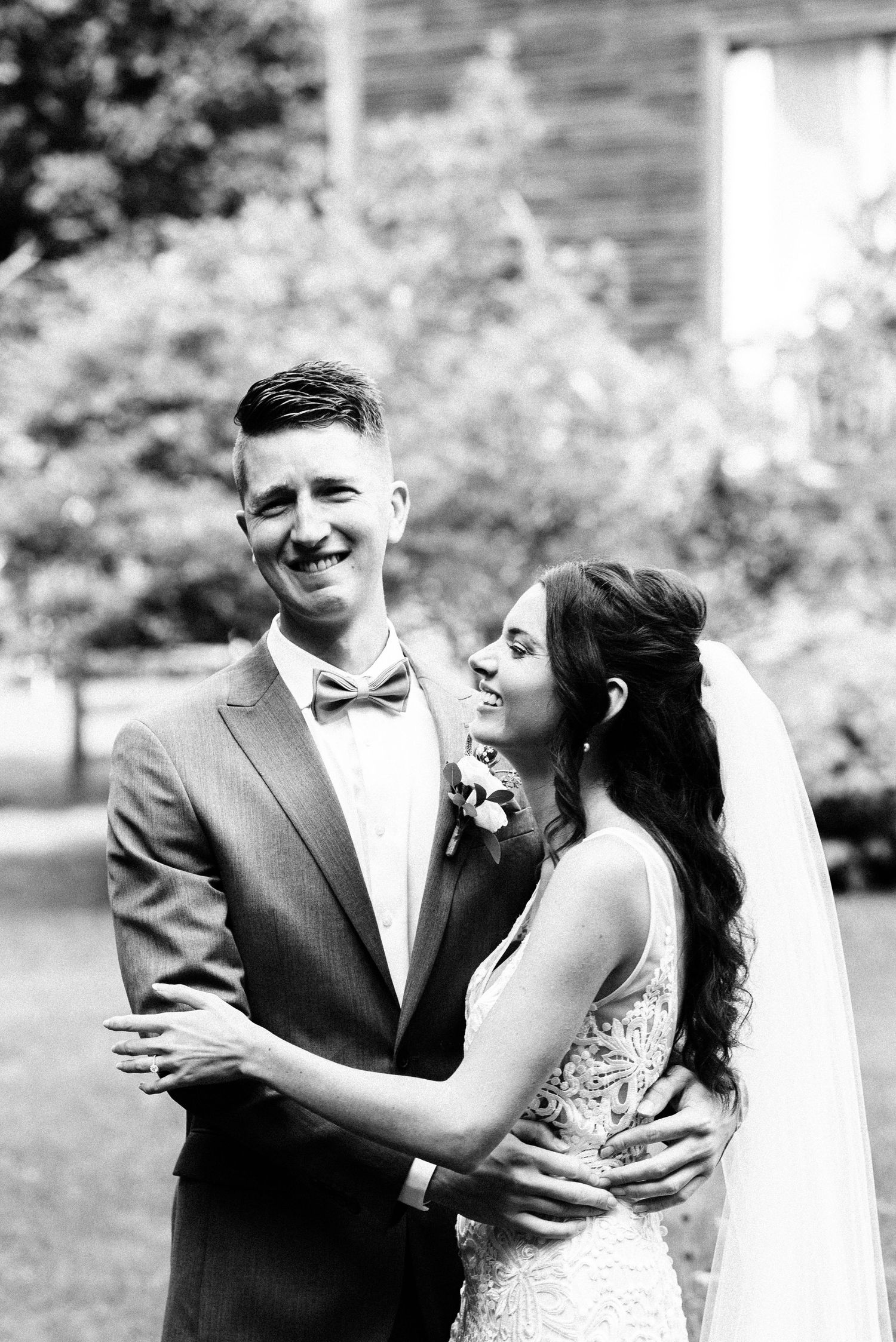 a groom is overcome with emotion as he holds his bride