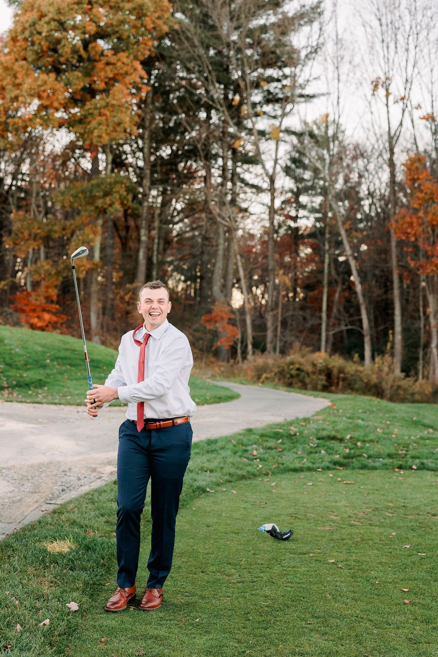 a groom takes a golf swing