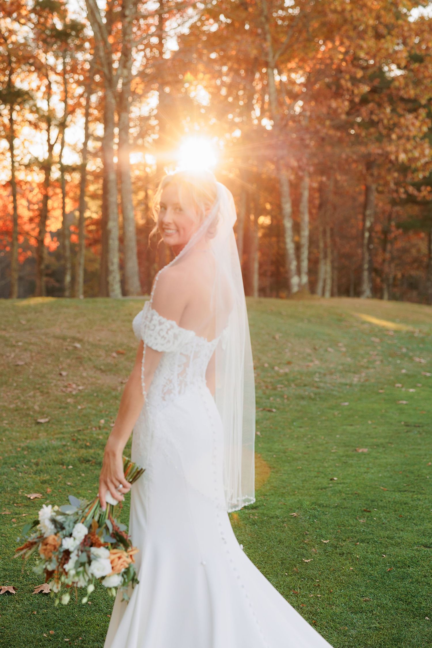 a bride poses for a portrait during sunset