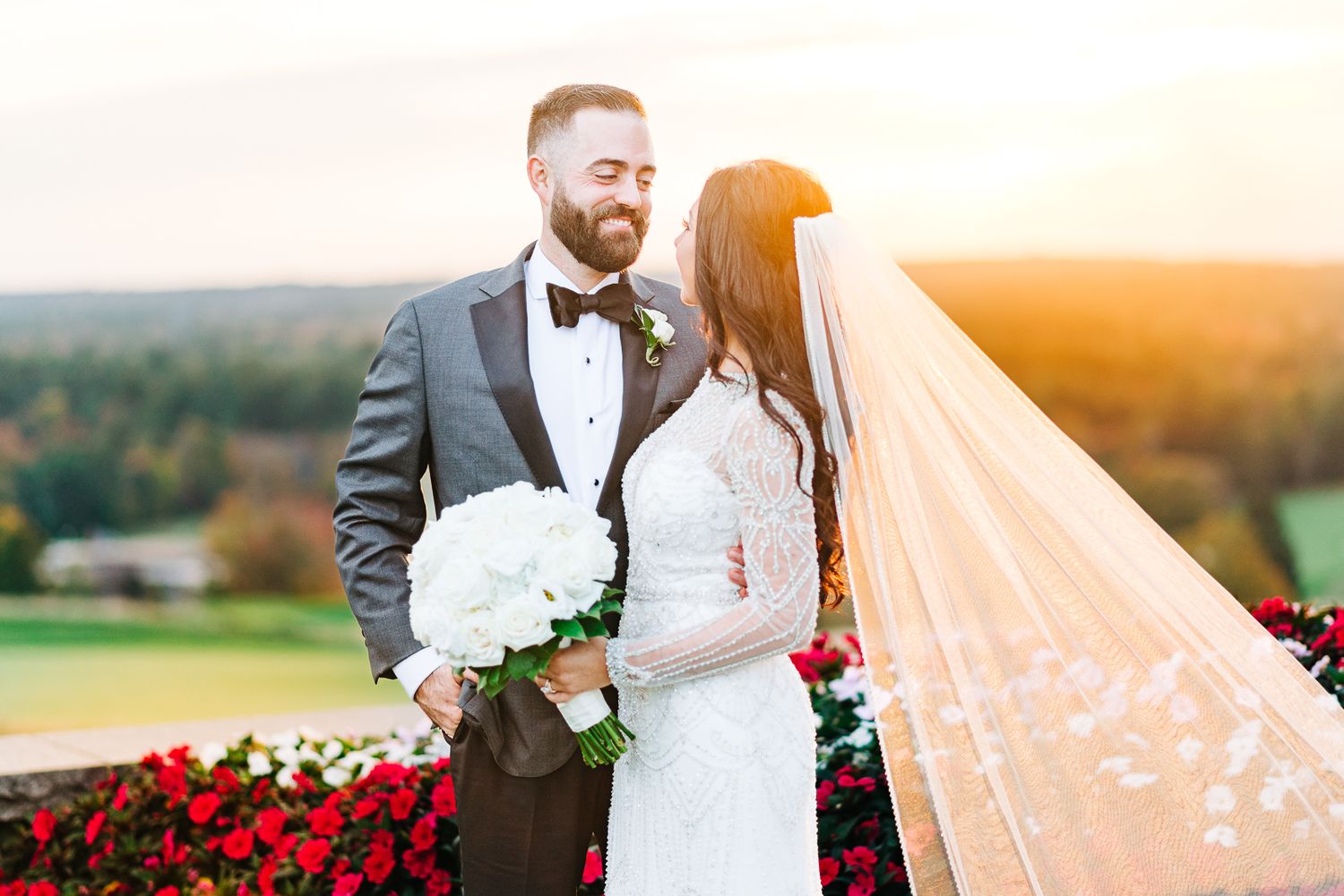 A bride and groom looking at each other during sunset for their golf course wedding.